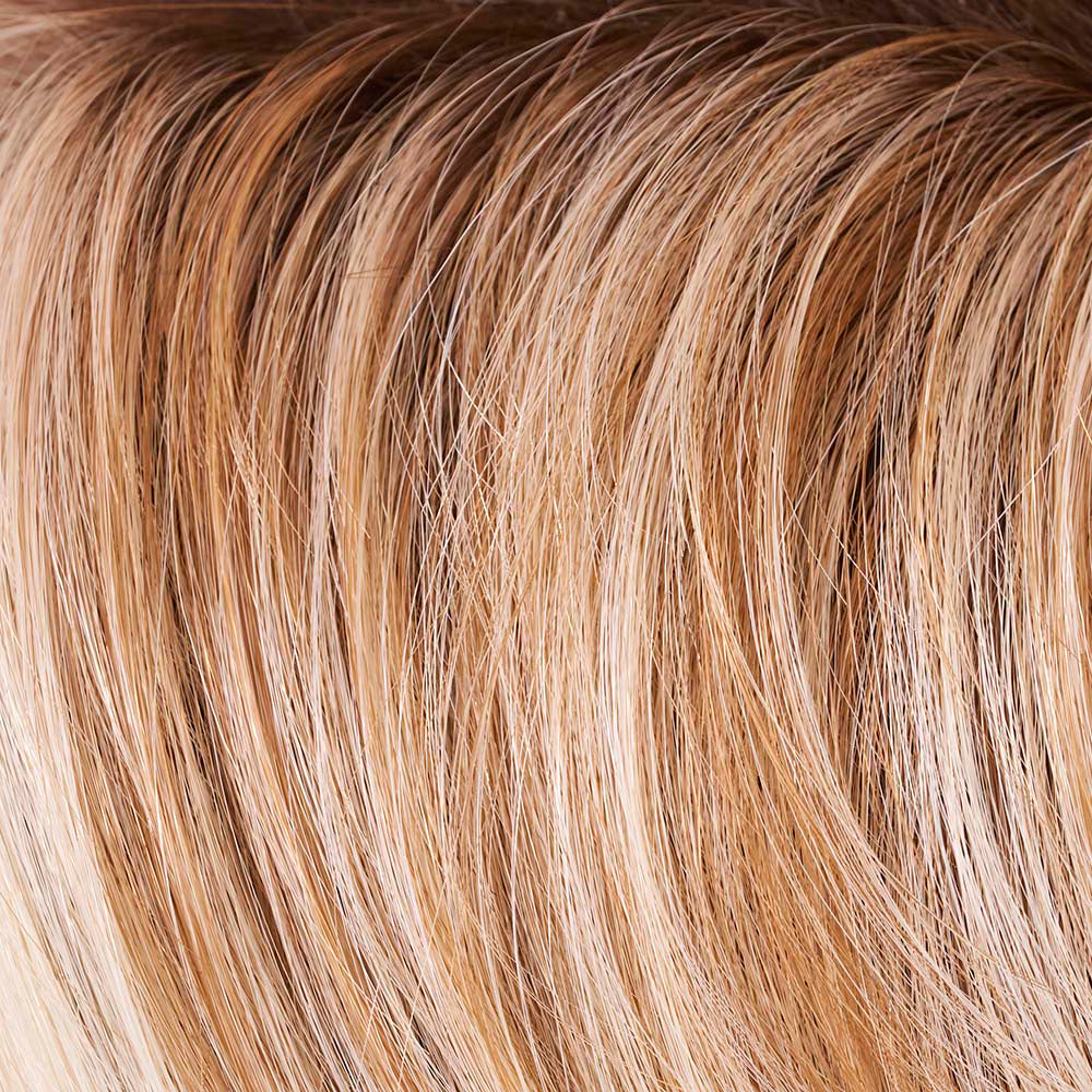 Close-up of blonde hair extensions with a gradient from light to dark.