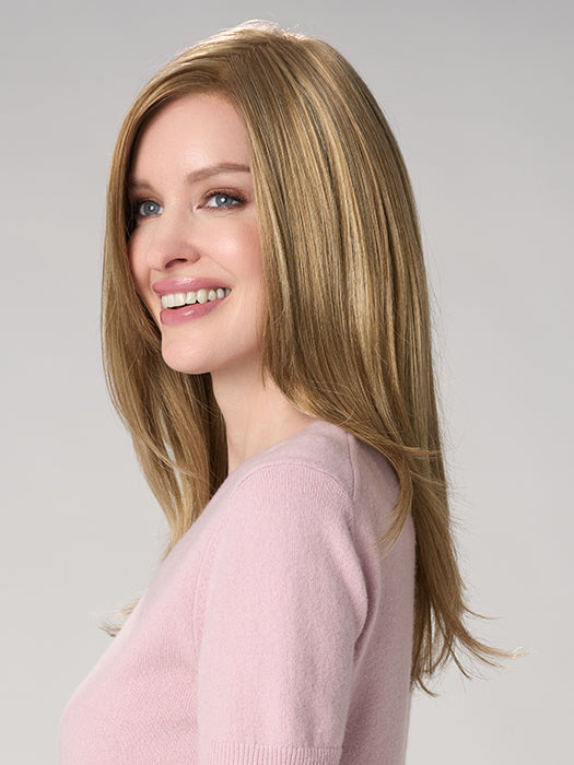 Woman with long, straight blonde hair wearing a pink sweater on a gray background
