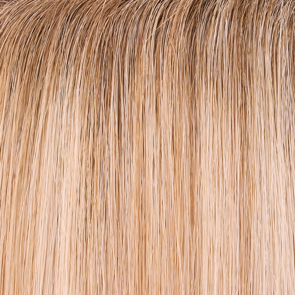 Close-up of blonde hair extensions with a gradient from light to dark.