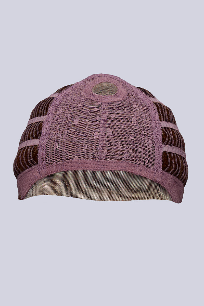 Pink and brown patterned cap on a light gray background