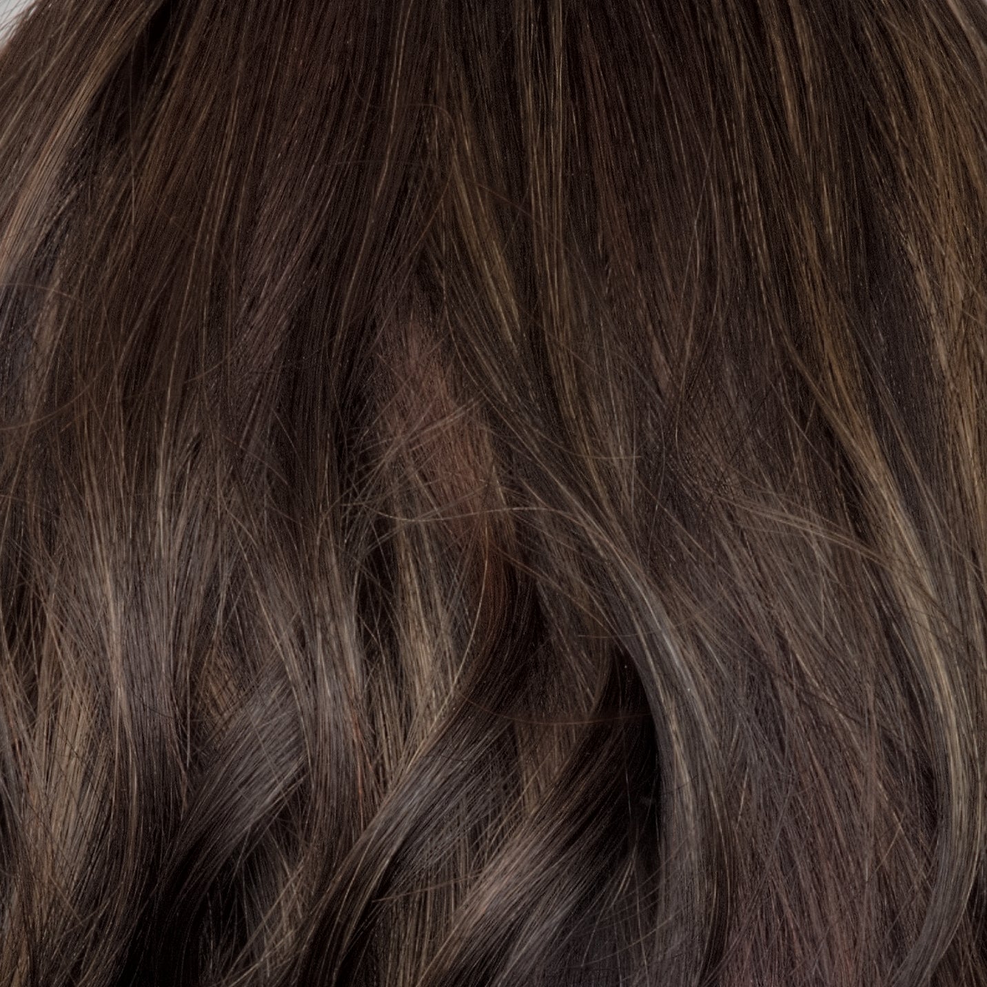 Close-up of brown hair with a focus on texture and color.